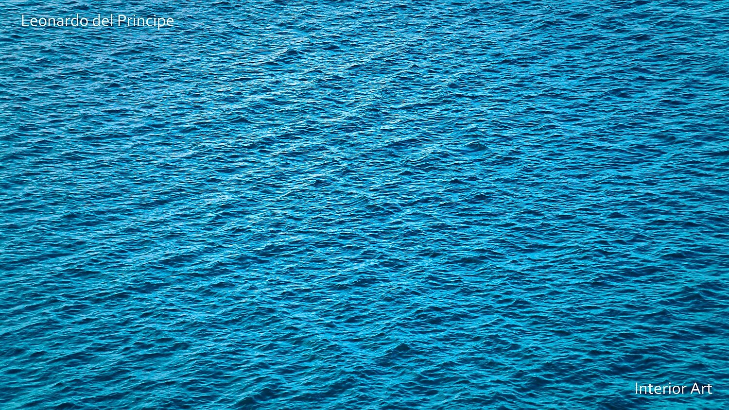 ESEAa05 Vivid ocean surface with gentle waves creating a textured pattern. The deep blue water conveys a sense of calm and tranquility.