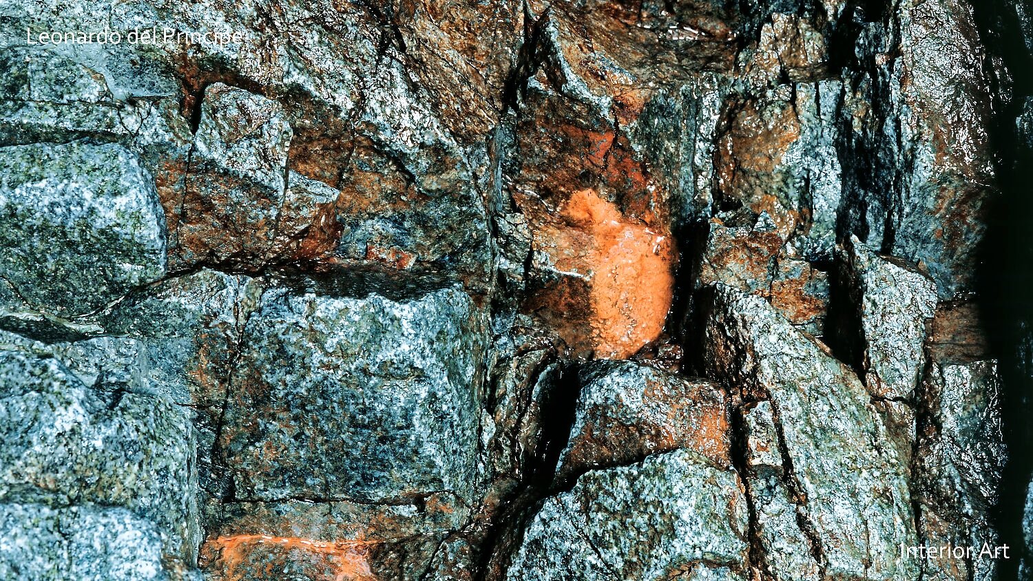 EGRT01 A close-up of a rugged rock face with a mix of gray and reddish-brown tones. The texture is rough and uneven, conveying a natural, earthy feel.